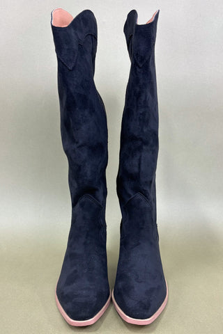 Navy blue knee-high boots with pink soles on a light gray background
