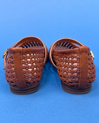 A pair of woven brown leather Mary Jane flats
