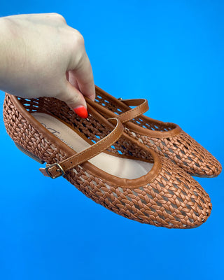 A pair of woven brown leather Mary Jane flats