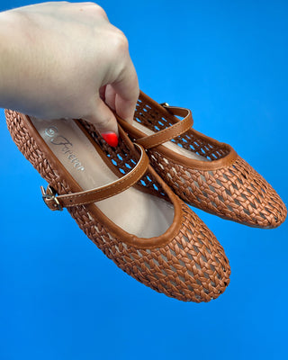 A pair of woven brown leather Mary Jane flats