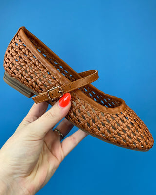 A pair of woven brown leather Mary Jane flats