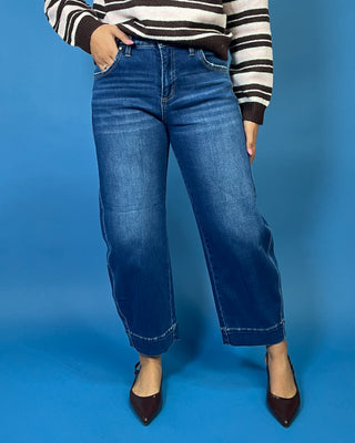 Dark wash high rise wide leg crop jeans with subtle fading and seamed cuff hem detail.