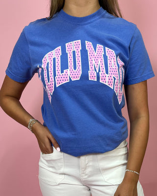 Person wearing a blue t-shirt with pink text on a pink background