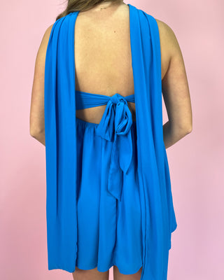 Blue dress with open back on a pink background