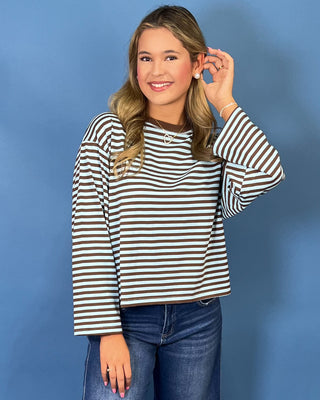 Light blue and brown striped long sleeve top with crew neckline, relaxed fit, and wide sleeves.