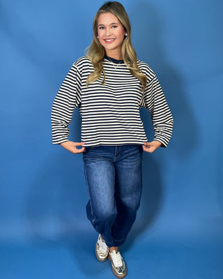Navy and cream striped long sleeve top with contrast neckline, relaxed fit, and wide sleeves.