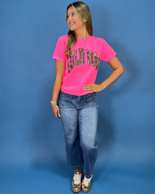a bright pink t-shirt with 'LULU MAC' printed in a camo-print arched graphic across the chest