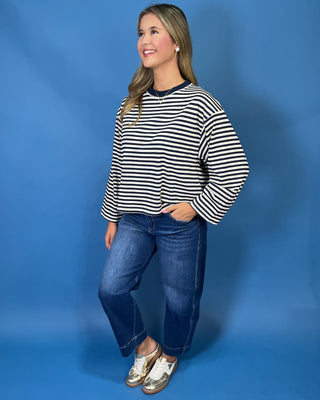 Navy and cream striped long sleeve top with contrast neckline, relaxed fit, and wide sleeves.
