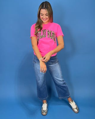 a bright pink t-shirt with 'LULU MAC' printed in a camo-print arched graphic across the chest