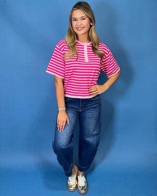 Hot pink and light pink striped short sleeve top with button henley neckline and relaxed fit.