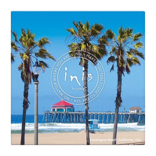 Beach scene with palm trees and a pier, featuring the 'inis' brand logo.