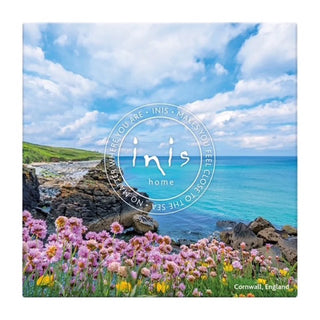 Scenic view of a coastal landscape with pink flowers and the 'inis home' logo.
