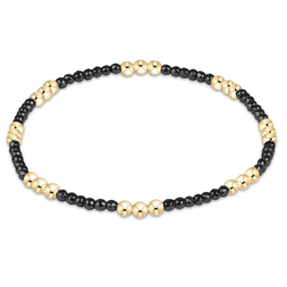 Shop the Joy Hematite 2mm Bracelet by enewton, featuring delicate dark hematite beads and polished gold accents. Perfect for everyday wear and layering.