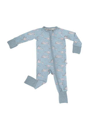A baby's long-sleeve footed sleeper in light blue with a repeating pattern of pink and white cranes, featuring a front zipper and ribbed cuffs and footings.