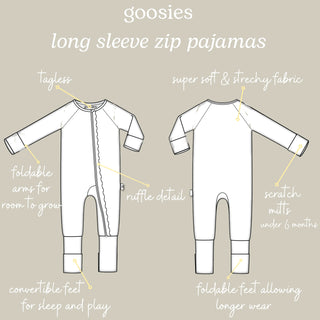 A product information graphic showing front and back line drawings of white long-sleeve zip pajamas with handwritten callouts and labels on a light beige background.