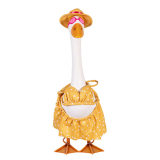 Plush toy goose in a yellow outfit with a hat on a white background