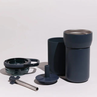 Set of dark blue travel mug components on a light background