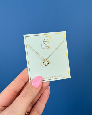 Enewton Gold Open Heart Charm Necklace featuring a polished open heart pendant on a delicate 16-inch gold chain displayed on