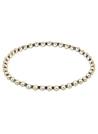 Necklace with gold and blue beads on a white background
