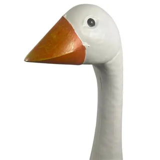 Close-up of a goose head with a white face and orange beak on a white background