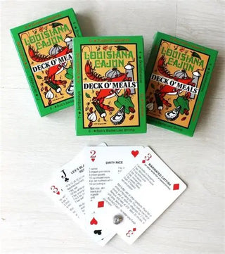 Three 'Louisiana Cajun Deck O' Meals' card decks on a white surface with playing cards displayed.