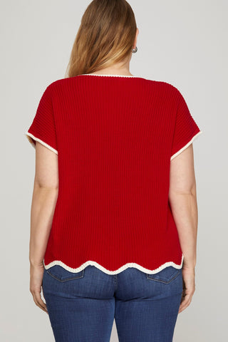 Red scalloped hem top worn by a person on a plain background