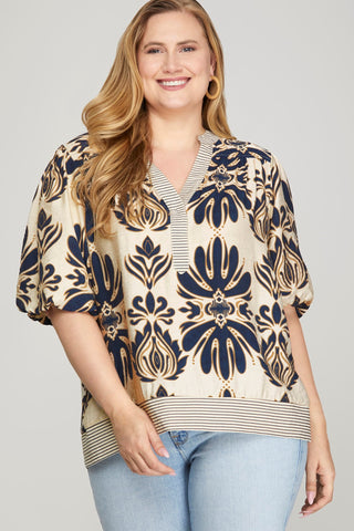 Woman wearing a patterned blouse with a plain background