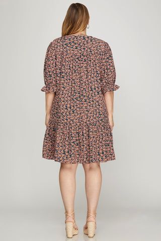 Woman wearing a floral dress on a plain background