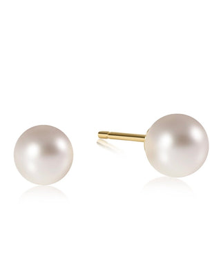 Enewton Classic Pearl Stud Earrings featuring luminous white faux pearls with 14kt gold-filled posts displayed on an Enewton