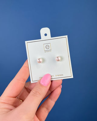 Enewton Classic Pearl Stud Earrings featuring luminous white faux pearls with 14kt gold-filled posts displayed on an Enewton