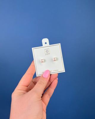 Enewton Classic Pearl Stud Earrings featuring luminous white faux pearls with 14kt gold-filled posts displayed on an Enewton