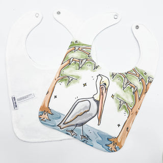 Two bibs with a pelican design on a white background