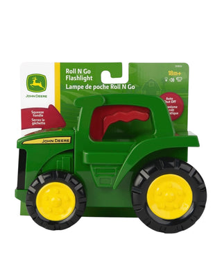 John Deere Roll N Go Flashlight toy in its original green and white cardboard packaging, featuring a green plastic tractor body with yellow wheels and a red interior.