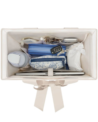 Case Mate Tote Bag Organizer Inserts in Colors Mulberry, Ballet Pink, & French Vanilla displayed against a slid blue background. 