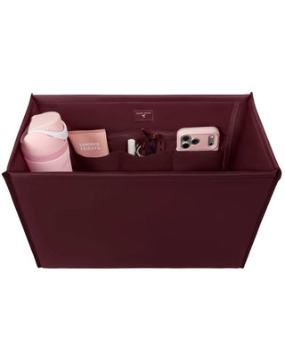 Case Mate Tote Bag Organizer Inserts in Colors Mulberry, Ballet Pink, & French Vanilla displayed against a slid blue background. 