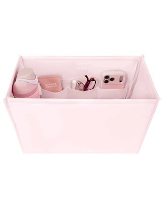 Case Mate Tote Bag Organizer Inserts in Colors Mulberry, Ballet Pink, & French Vanilla displayed against a slid blue background. 