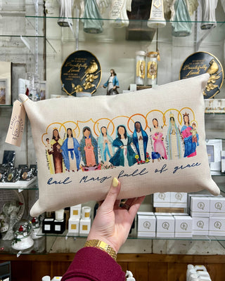 Pillow with illustrated figures and text held in front of a store display