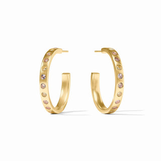 Gold hoop earrings with pink gemstones on a white background