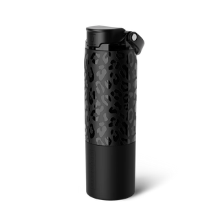 Hand holding a black mug with 'Rise' text in a store setting with various products and people in the background.