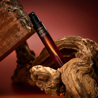 Perfume bottle on a wooden surface with a warm color palette