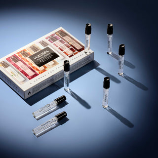 VOLUSPA perfume set with multiple bottles on a blue background