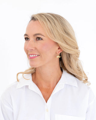 Woman with blonde hair wearing a white shirt on a white background