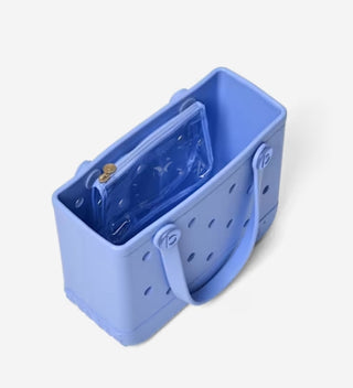 Blue handbag with a clear plastic compartment on a white background