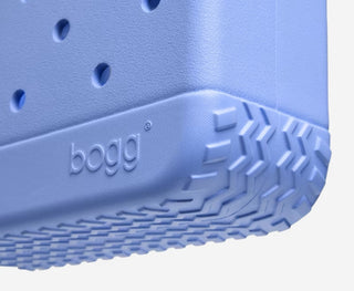 Close-up of a blue bogg bag with textured bottom and brand name.