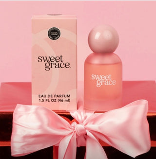 Sweet Grace perfume bottle and packaging on a pink background