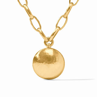Gold necklace with a round pendant on a white background