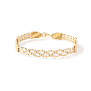 Gold braided bracelet on a white background