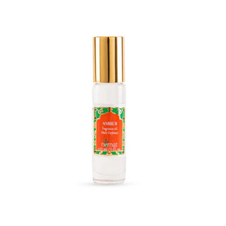 Nemat Amber fragrance oil roll-on in a clear glass bottle with a decorative red and green label and gold cap.