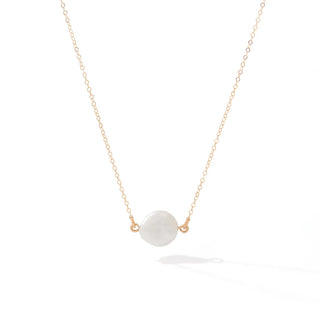 Necklace with a white pendant on a gold chain against a white background