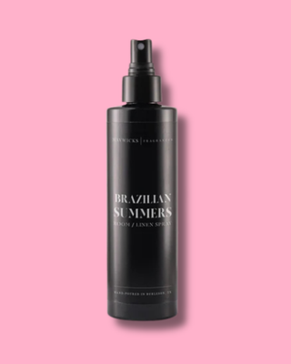Black spray bottle labeled 'Brazilian Summers' on a pink background